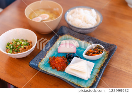 Japanese breakfast table: miso soup, rice and colorful side dishes 122999982