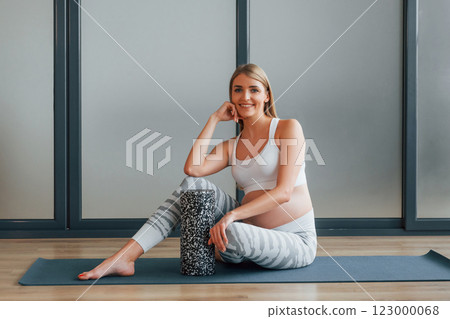 Yoga for pregnant. Woman in sportive clothes is in the studio 123000068