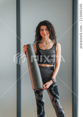 Woman in sportive clothes is in the studio 123000100