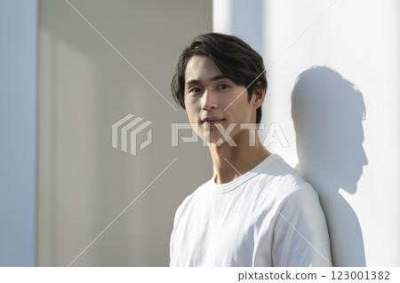 A man in his 20s wearing a white T-shirt looking at the camera Men's beauty and skin care image portrait A man in his 20s wearing a white T-shirt looking at the camera Men's beauty and skin care image portrait 123001382