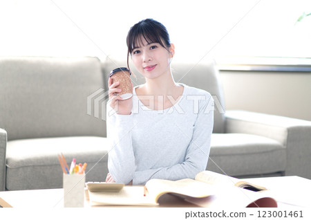 A young woman studying alone in the living room A young woman studying alone in the living room 123001461