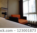 Hotel room interior with large chair and window view 123001873