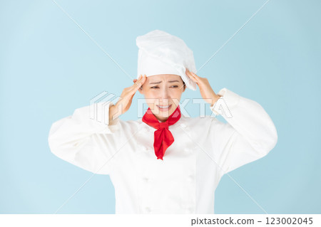 Female chef cook coat holding head 123002045