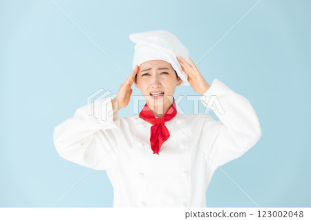 Female chef cook coat holding head 123002048