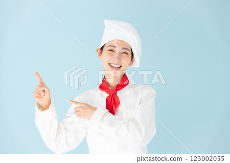 Female chef cook coat pointing 123002055