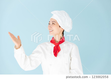 Female chef cook coat hand wave Female chef cook coat hand wave 123002058