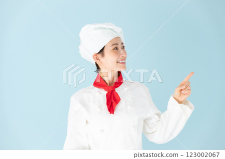 Female chef cook coat pointing Female chef cook coat pointing 123002067