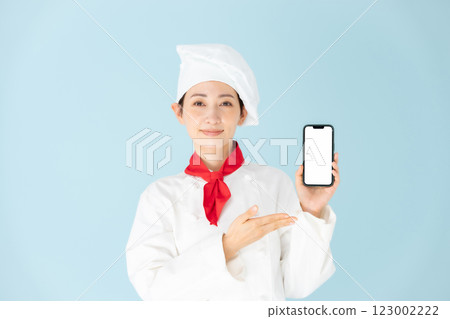 Female chef cook coat smartphone smile Female chef cook coat smartphone smile 123002222