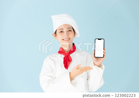 Female chef cook coat smartphone smile 123002223