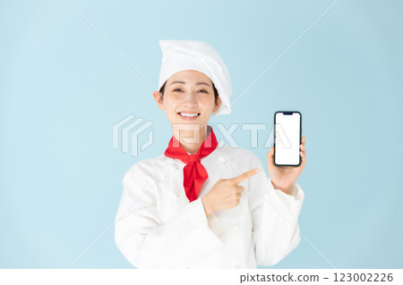 Female chef cook coat smartphone smile Female chef cook coat smartphone smile 123002226