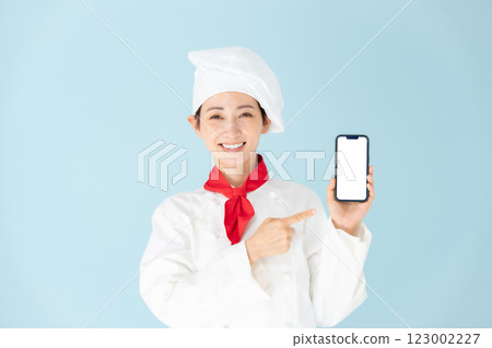 Female chef cook coat smartphone smile Female chef cook coat smartphone smile 123002227