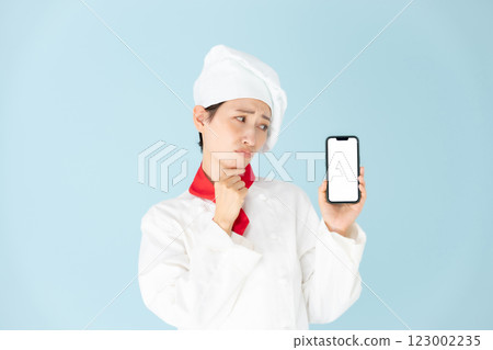 Female chef cook coat smartphone worries Female chef cook coat smartphone worries 123002235