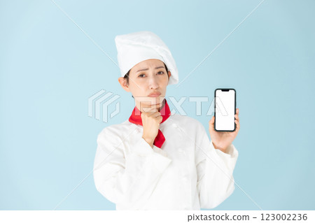 Female chef cook coat smartphone worries Female chef cook coat smartphone worries 123002236
