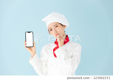 Female chef cook coat smartphone worries Female chef cook coat smartphone worries 123002251