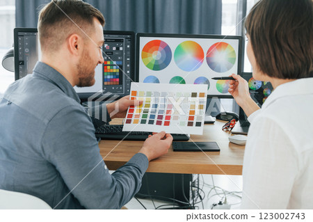 Talking with each other about new ideas. Two designers working together in the office 123002743