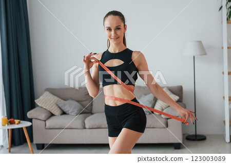 Slim body type. Young woman in yoga clothes is at home Slim body type. Young woman in yoga clothes is at home 123003089