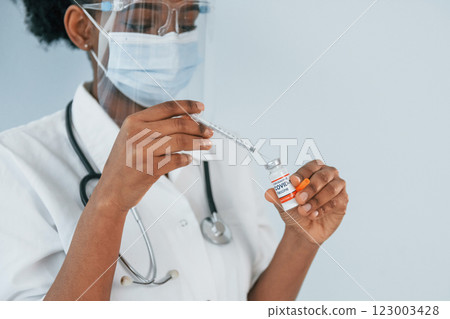 Young african american doctor is against white background Young african american doctor is against white background 123003428