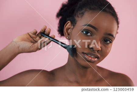 Clean skin conception. Portrait of young african american woman that is against pink background Clean skin conception. Portrait of young african american woman that is against pink background 123003459