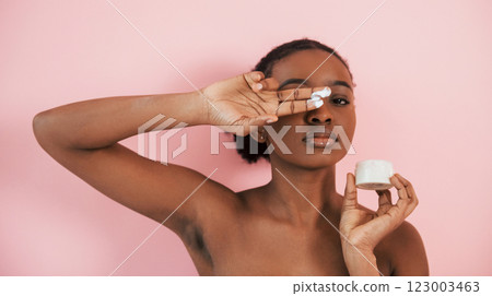 Clean skin conception. Portrait of young african american woman that is against pink background Clean skin conception. Portrait of young african american woman that is against pink background 123003463