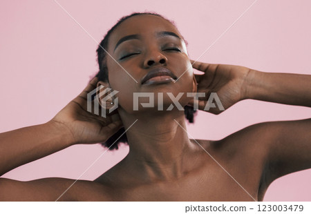 Posing for a camera. Portrait of young african american woman that is against pink background 123003479