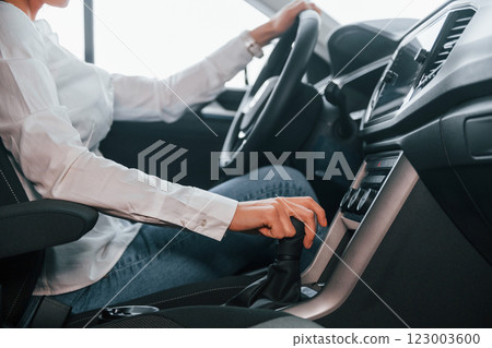 Close up view of front panel. Woman is in autosalon at daytime Close up view of front panel. Woman is in autosalon at daytime 123003600