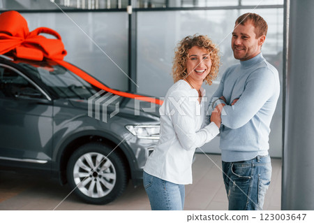 Feeling happiness. Husband makes gift for his wife. Modern new car Feeling happiness. Husband makes gift for his wife. Modern new car 123003647