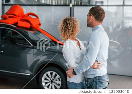 Feeling happiness. Husband makes gift for his wife. Modern new car Feeling happiness. Husband makes gift for his wife. Modern new car 123003648