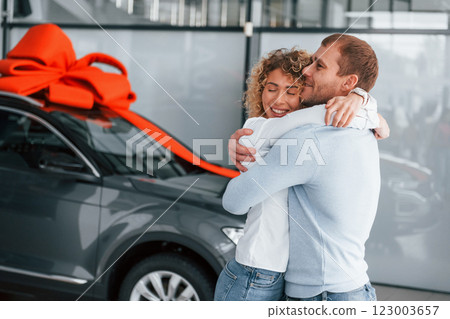 Proor of love. Husband makes gift for his wife. Modern new car 123003657