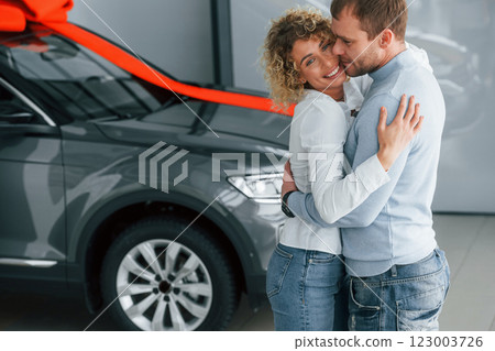 Husband makes gift for his wife. Modern new car Husband makes gift for his wife. Modern new car 123003726