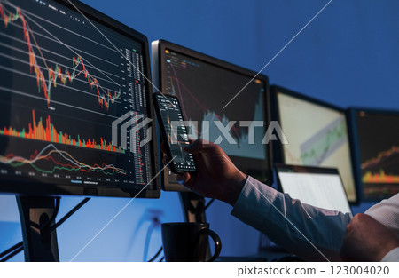 Analyzing data. Stock trader working in the office with exchange technology 123004020