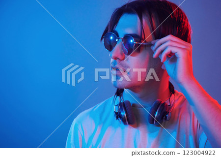 Conception of futuristics. Man standing in the studio with neon light 123004922