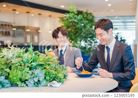 Businessmen having lunch in a stylish office cafeteria 123005195