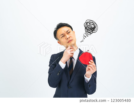 A middle-aged male business person having trouble carrying his wallet 123005480