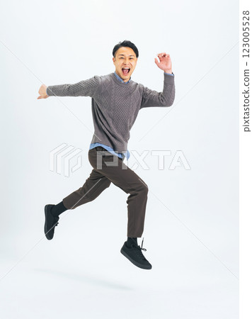 Full body photo of a middle-aged man in casual clothing jumping Full body photo of a middle-aged man in casual clothing jumping 123005528