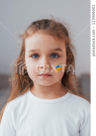 Portrait of little girl with Ukrainian flag make up on the face Portrait of little girl with Ukrainian flag make up on the face 123006001