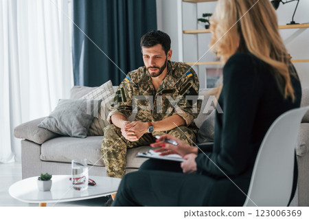 Soldier have therapy session with psychologist indoors 123006369