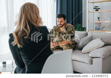 Soldier have therapy session with psychologist indoors 123006372