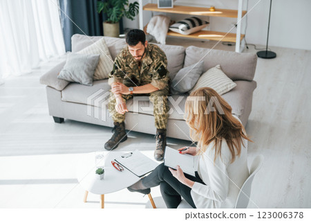 Having conversation. Soldier have therapy session with psychologist indoors 123006378