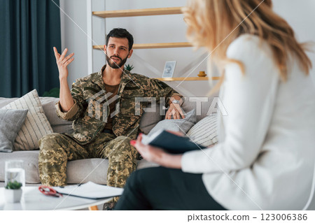 Process of therapy. Soldier is with psychologist indoors Process of therapy. Soldier is with psychologist indoors 123006386