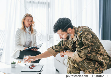 Process of recovery. Soldier have therapy session with psychologist indoors 123006405