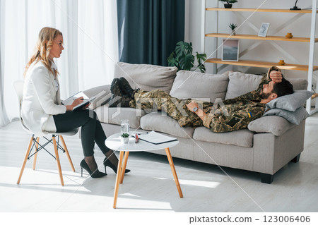 Process of recovery. Soldier have therapy session with psychologist indoors Process of recovery. Soldier have therapy session with psychologist indoors 123006406