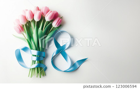 A bouquet of pink tulips lies next to the number eight of blue color from a satin ribbon on a pink background, 123006594
