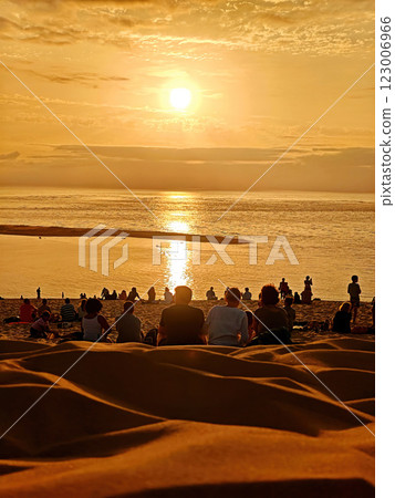 Sunset Landscape View from Dune of Pilat in France with Fine-Grained Sand Dunes and Mesmerized Sunset Watchers Sunset Landscape View from Dune of Pilat in France with Fine-Grained Sand Dunes and Mesmerized Sunset Watchers 123006966