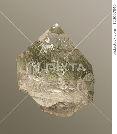 Detailed Close-Up View of Intricately Carved Quartz from the Alps Depicting Historical Scene on Light Background 123007046
