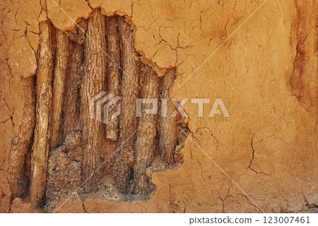 Close up view of wall maded from sand and wooden sticks Close up view of wall maded from sand and wooden sticks 123007461