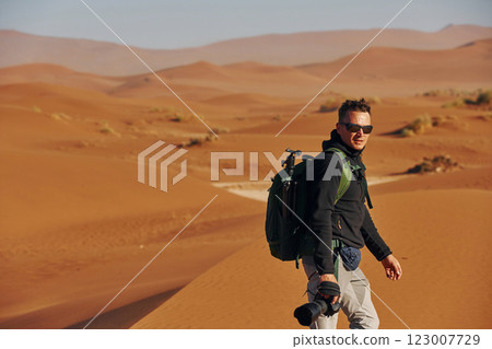 Photographer is working. Male tourist in casual clothes is in the deserts of Africa, Namibia 123007729