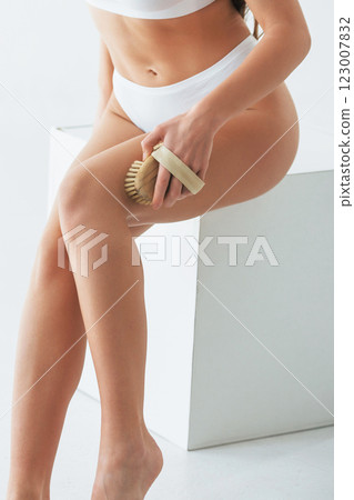 Cleaning the skin. Woman in underwear with slim body type is posing in the studio Cleaning the skin. Woman in underwear with slim body type is posing in the studio 123007832