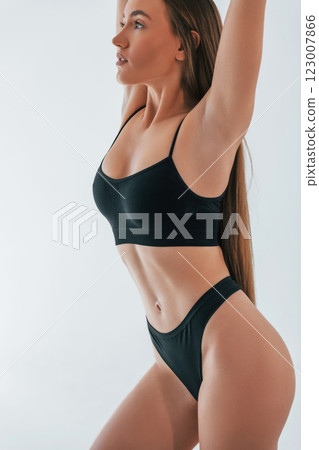 Fashion model. Woman in underwear with slim body type is posing in the studio Fashion model. Woman in underwear with slim body type is posing in the studio 123007866