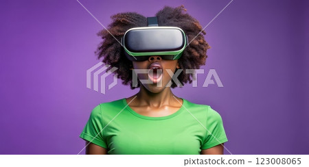 Teenager black girl experiencing virtual reality with joyful expression 123008065
