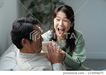 A wife in her 50s questions her husband 123008875